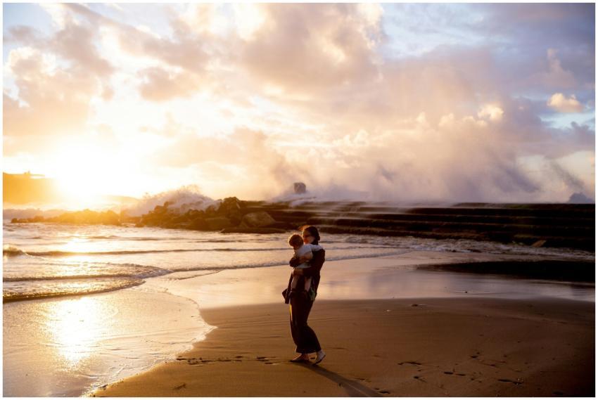 A heartwarming scene of a mother carrying her chil
