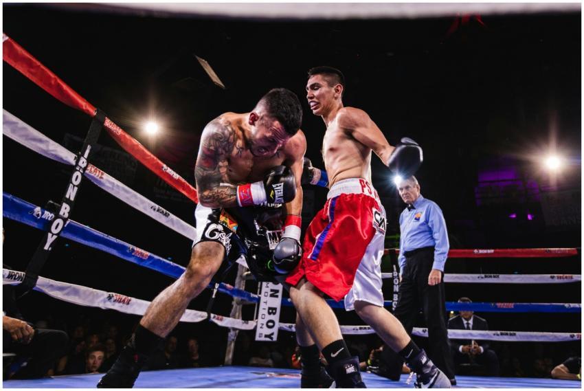A dynamic scene of two boxers in action during a f