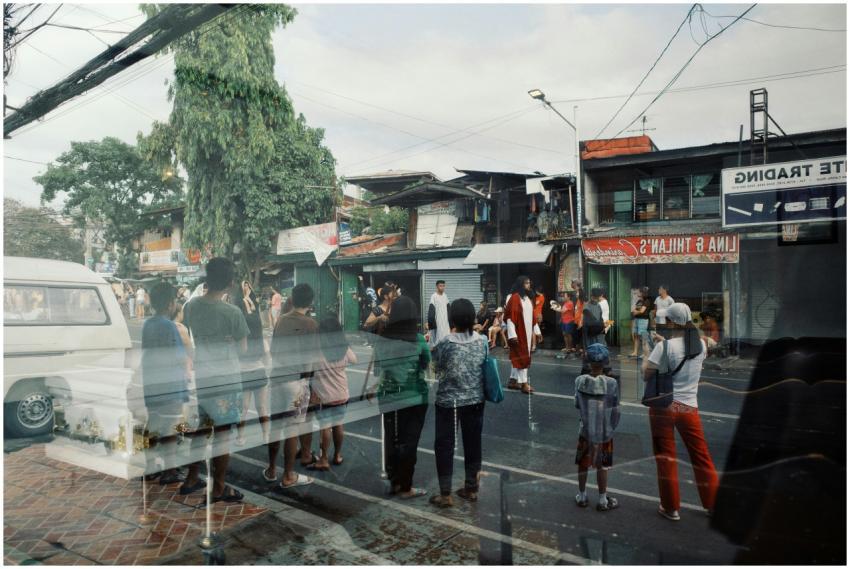 Urban street scene with people gathering, reflecte