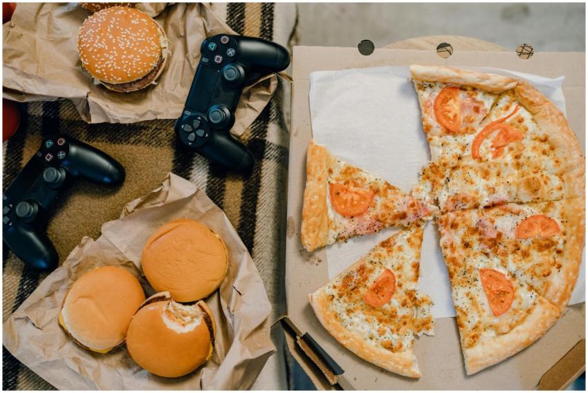 Aerial view of delicious pizza, burgers, and gamin