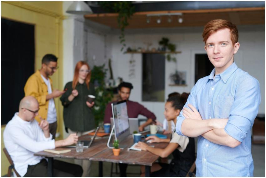 Young professional leading a diverse team in a con