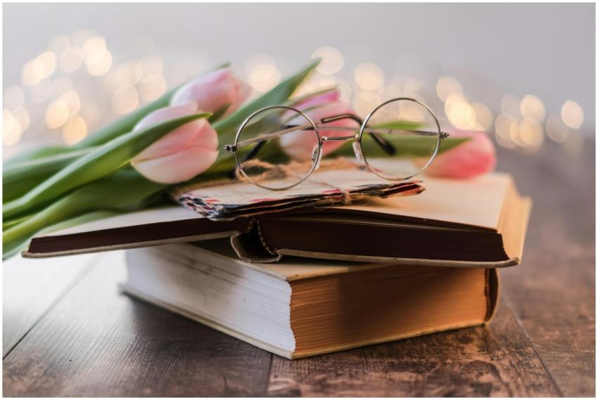 Artistic composition of vintage books, eyeglasses,