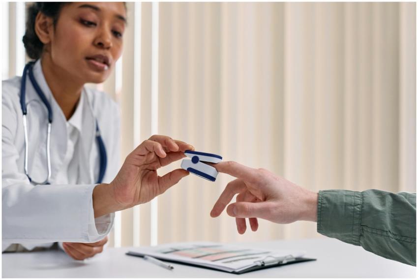Healthcare worker checking patient vitals with a p