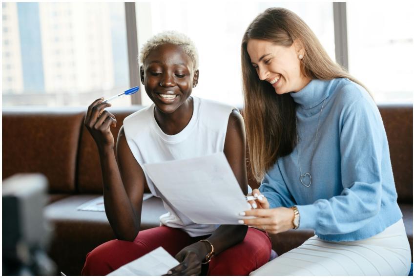 Positive diverse women checking information in doc