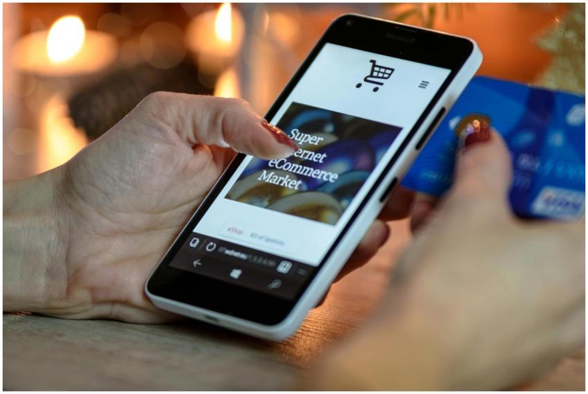 Woman using smartphone for online shopping with cr