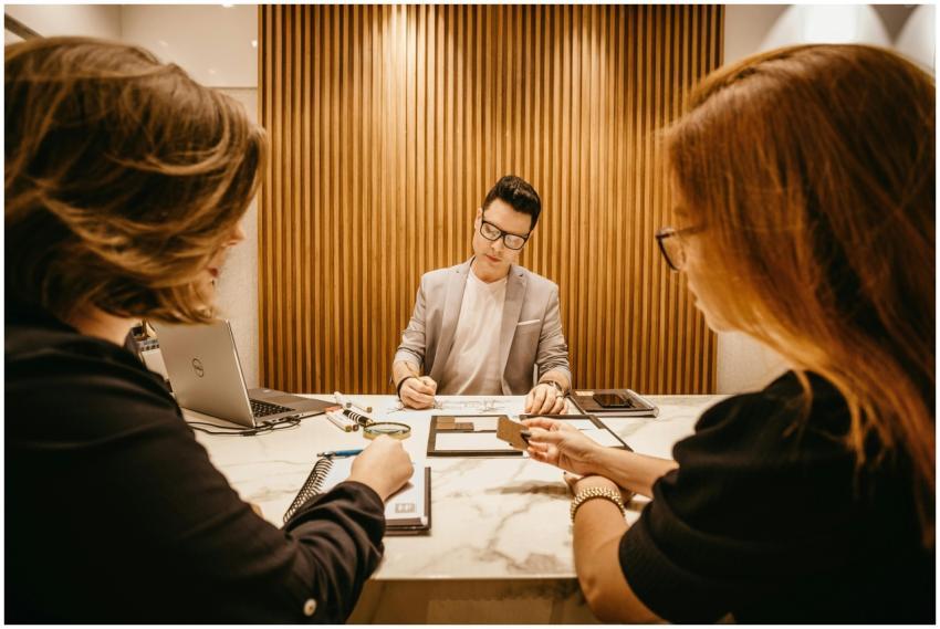 Three colleagues collaborate during a meeting in a