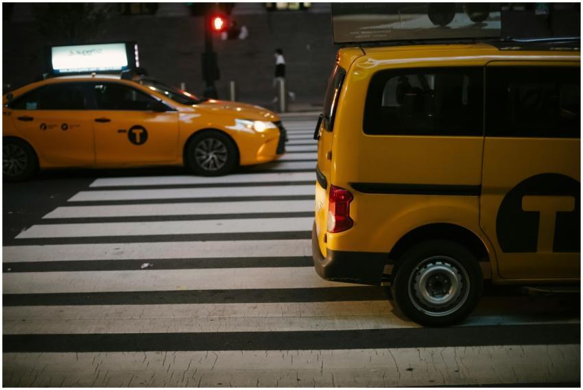Yellow taxis on a urban street at night, captured