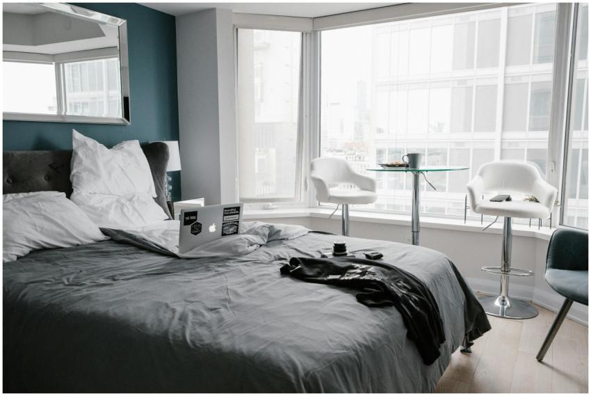 Contemporary hotel room in Toronto with bed, lapto