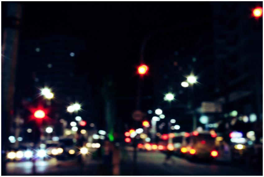 Blurred urban street with vibrant light streaks an