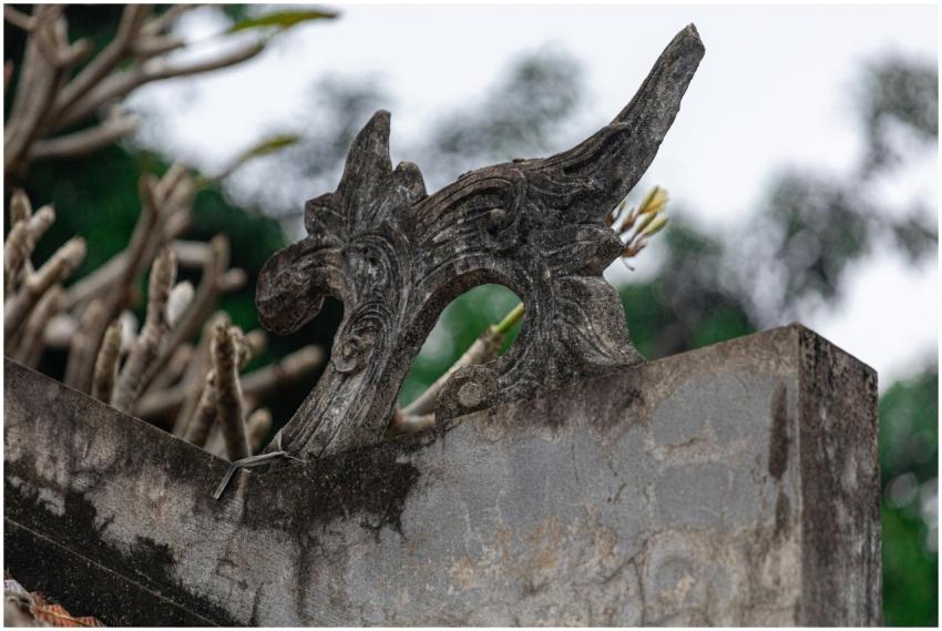 Intricate stone carving adorns a temple roof in Hà