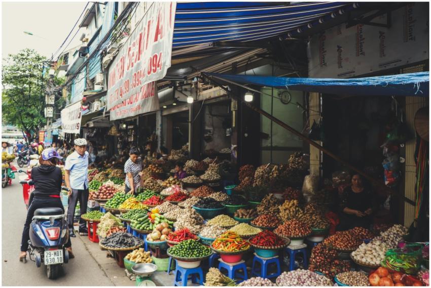 Bustling outdoor street market in Hanoi featuring