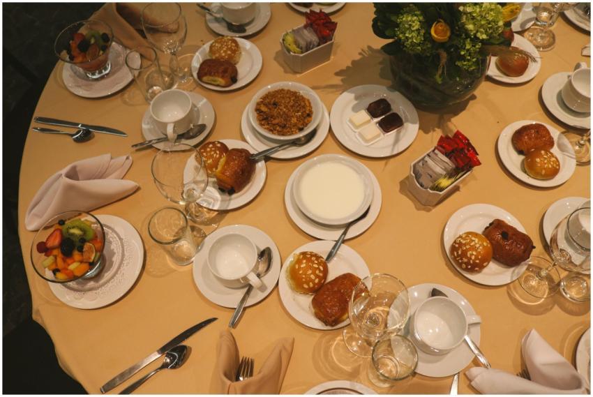 Top view of a breakfast table with pastries, fruit