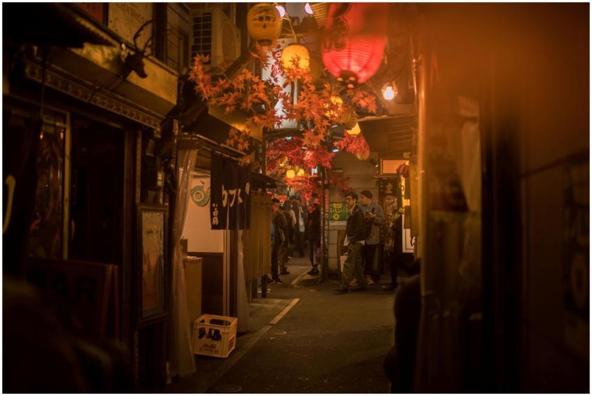Bustling Tokyo street scene at night with paper la