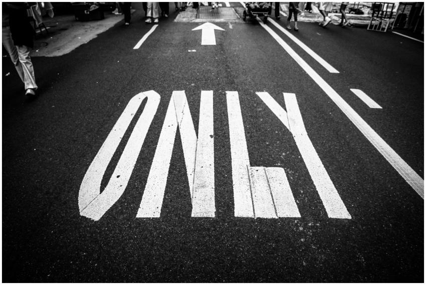 Black and white photo of road, showing traffic mar