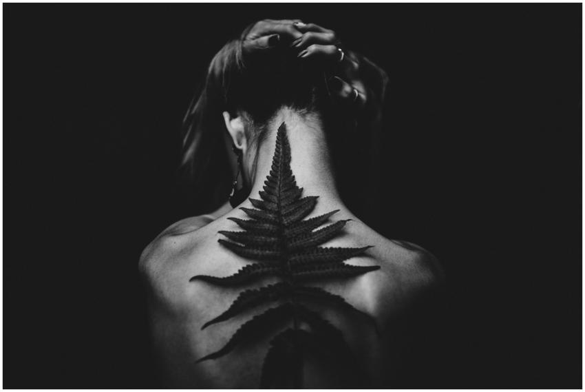 Black and white photo of a tattooed woman from the