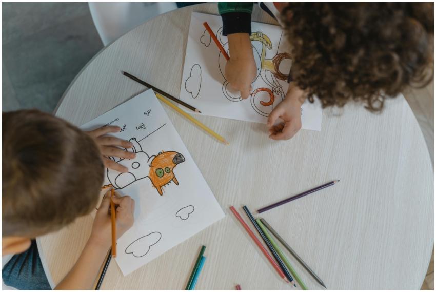 Overhead shot of children coloring, showcasing cre