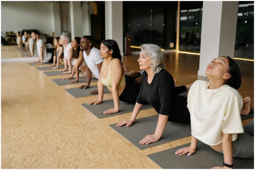 A diverse group of adults practice yoga indoors, d