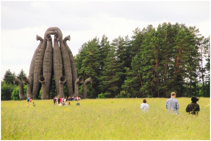 A group of people exploring a unique tower sculptu