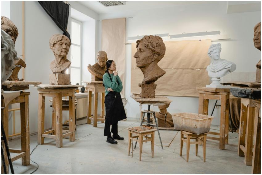 An artist in a creative clay sculpting studio surr