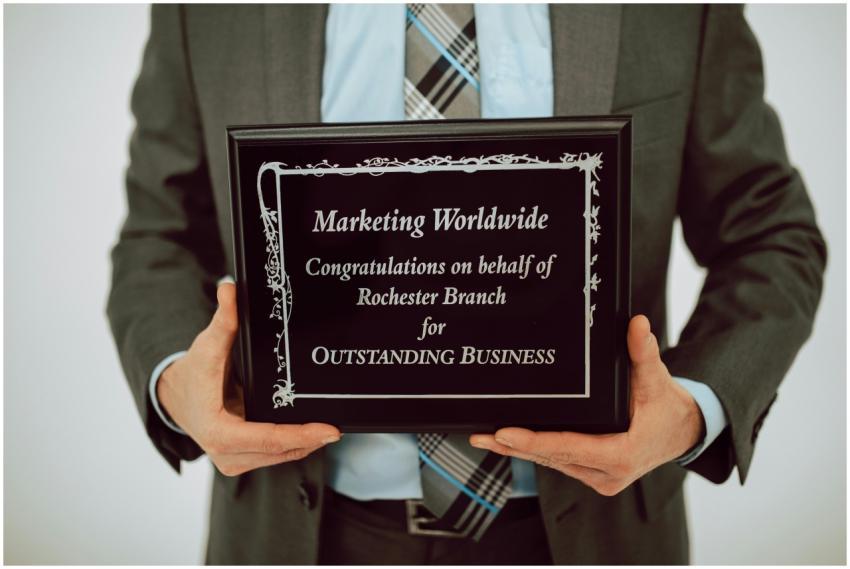 Businessperson holding an award for outstanding bu