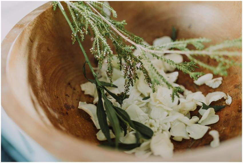 Wooden bowl filled with fresh herbs and flowers fo