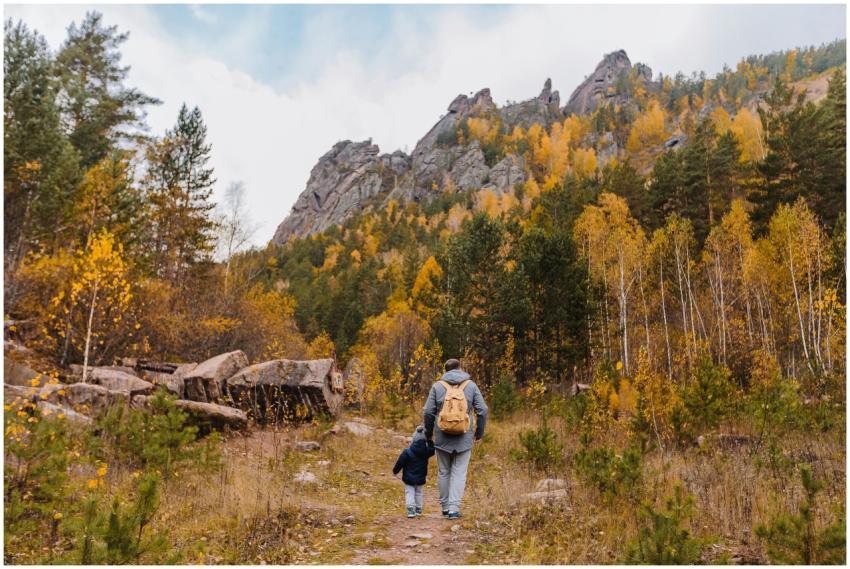 A father and son hiking together in an autumn moun
