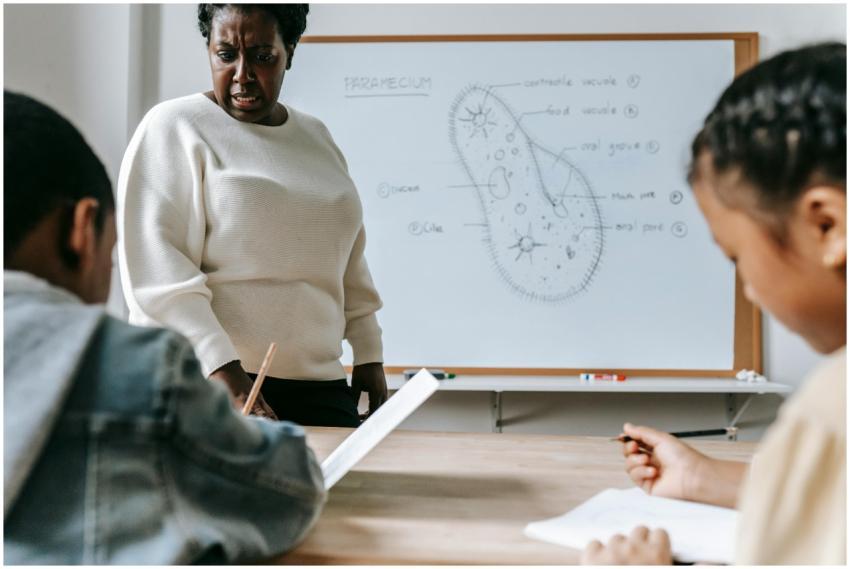 Teacher interacting with students during a biology