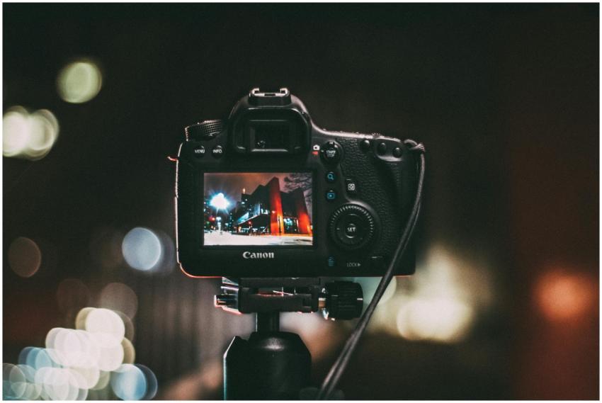Close-up of a camera capturing a vibrant urban sce