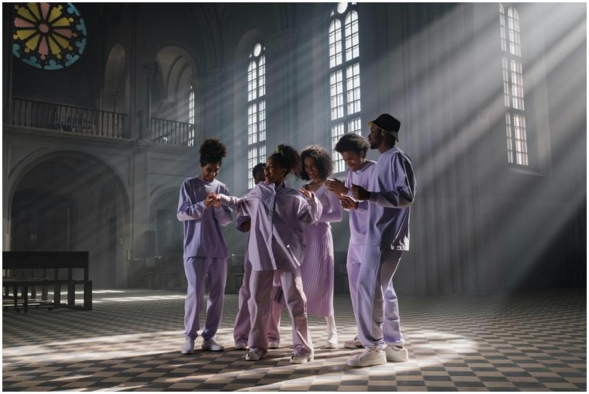 A gospel choir singing and dancing in a sunlit cat
