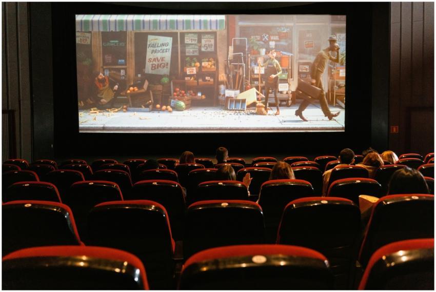 A cozy indoor movie theater showing an animated fi