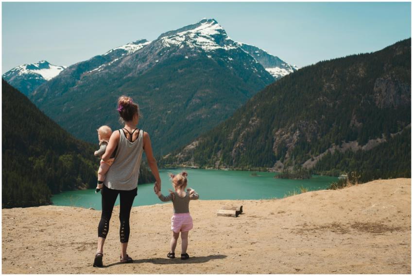 A mother with two children enjoys a scenic mountai