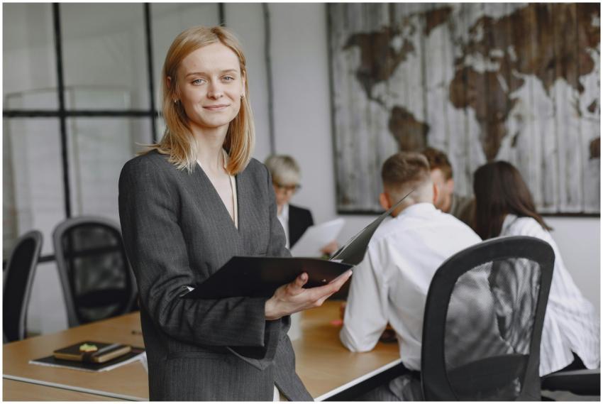 Confident businesswoman holding folder during a te