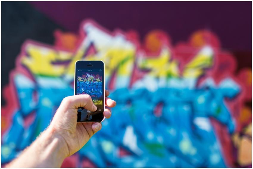 Close-up of hand holding a smartphone photographin