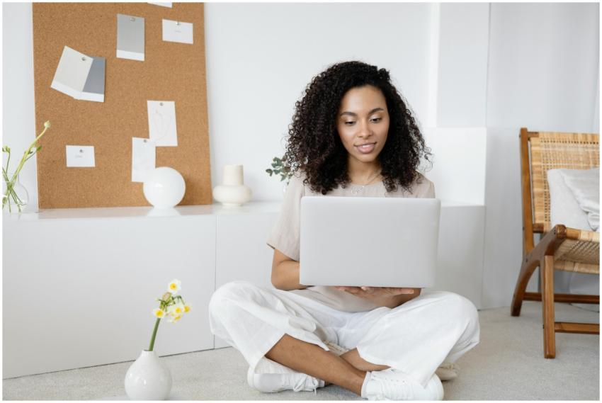Young woman with curly hair working on her laptop