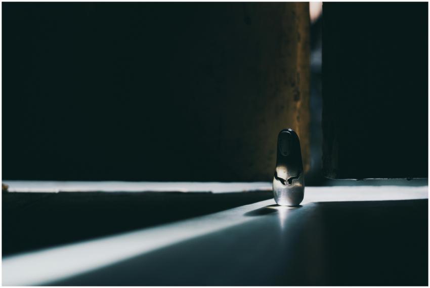 A lone figurine bathed in moody light creating dra