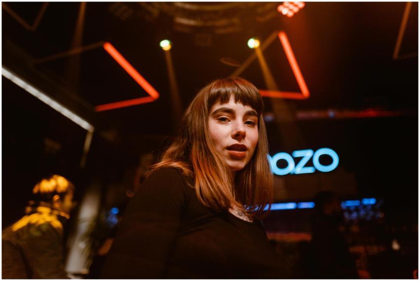 Woman with bangs enjoying a lively night out in a