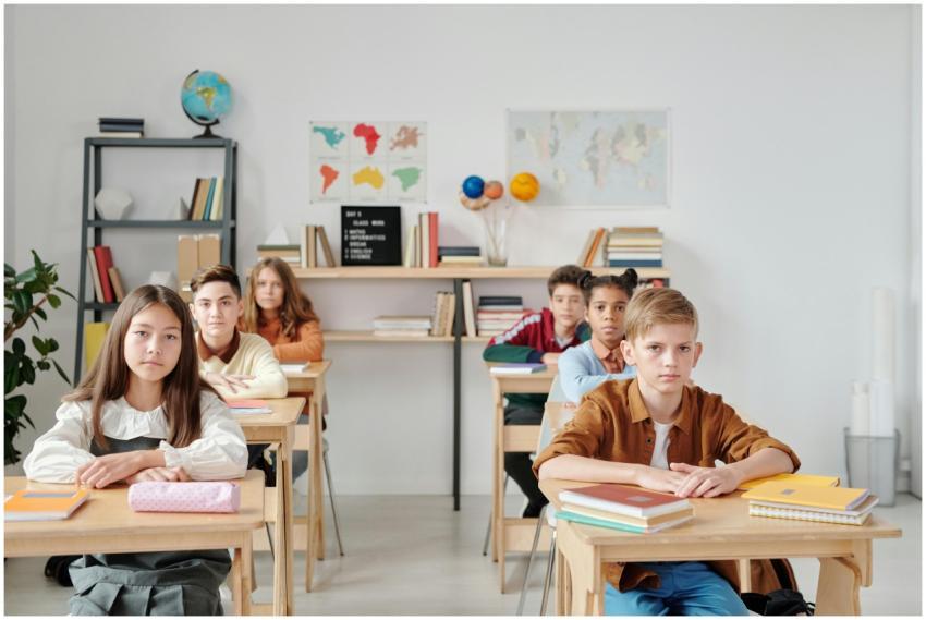 Students sit attentively in a modern classroom wit