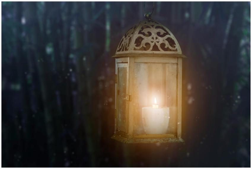 Warm glow of a candle inside a vintage lantern aga