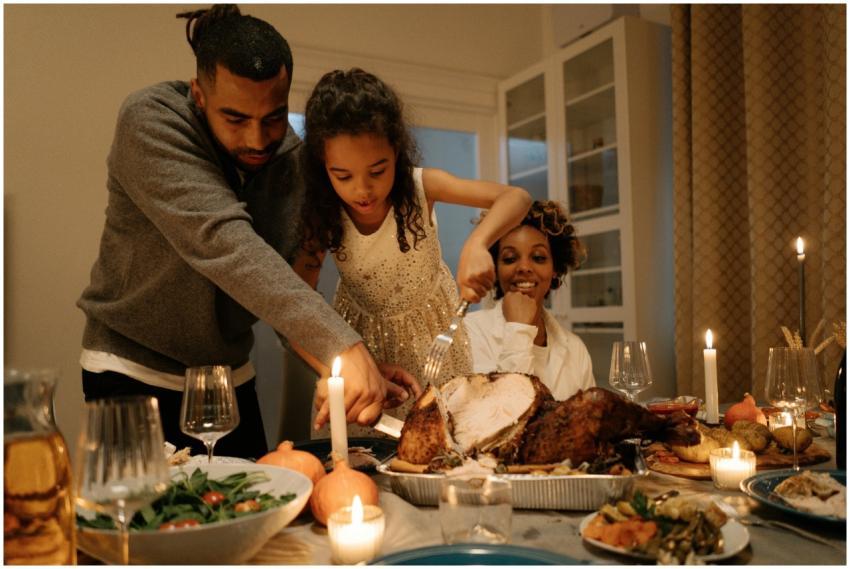 A joyful family gathering around a table to celebr