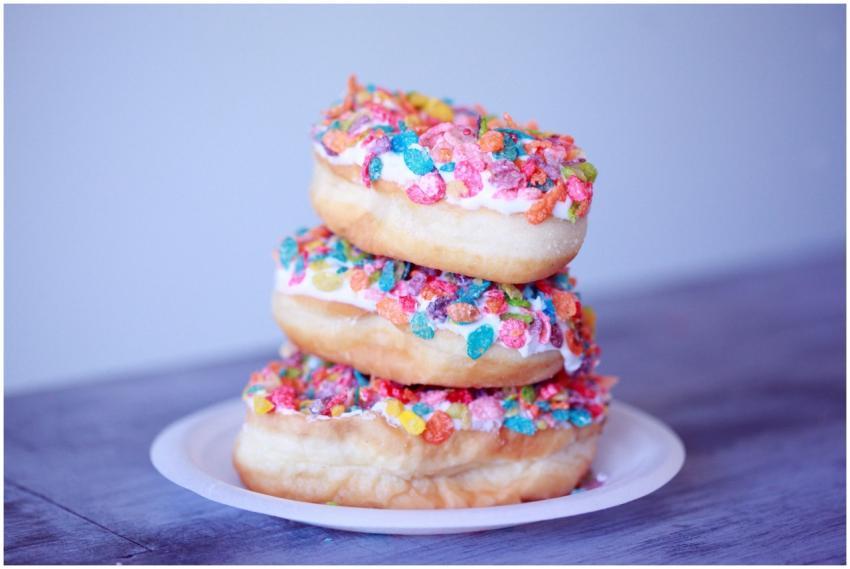 A stack of doughnuts covered in colorful fruity pe