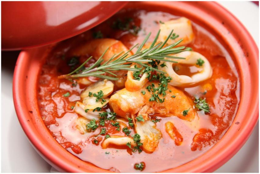 A warm seafood stew with herbs and vibrant tomato