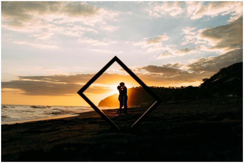 Silhouette of a couple embracing at sunset on a pi