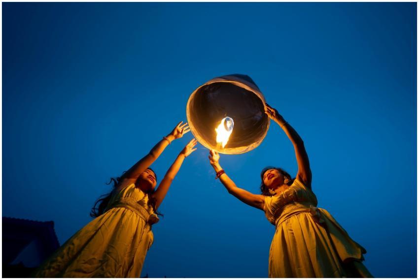 Two women in yellow dresses releasing a glowing sk