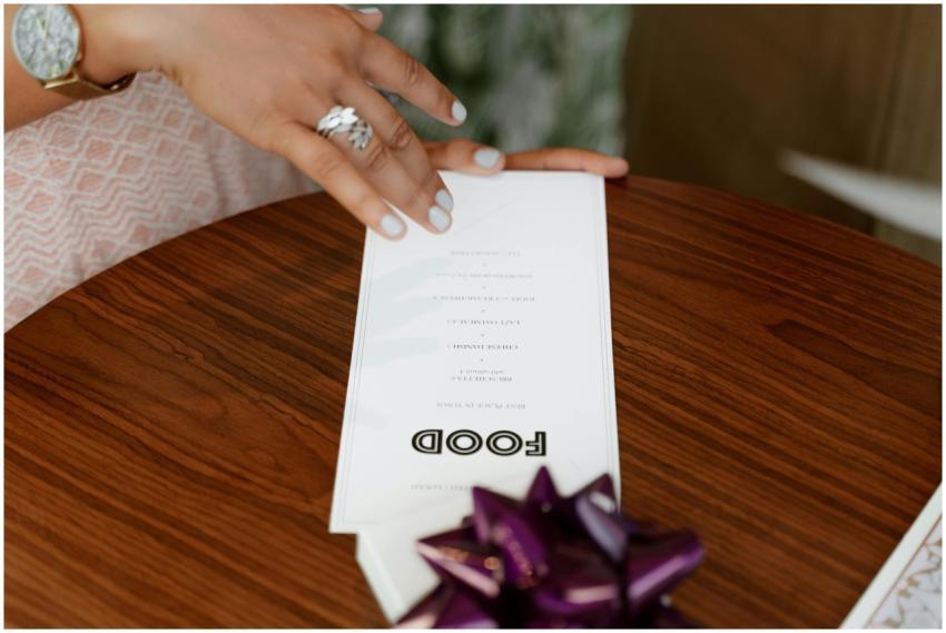 A detailed close-up of a hand holding a menu on a