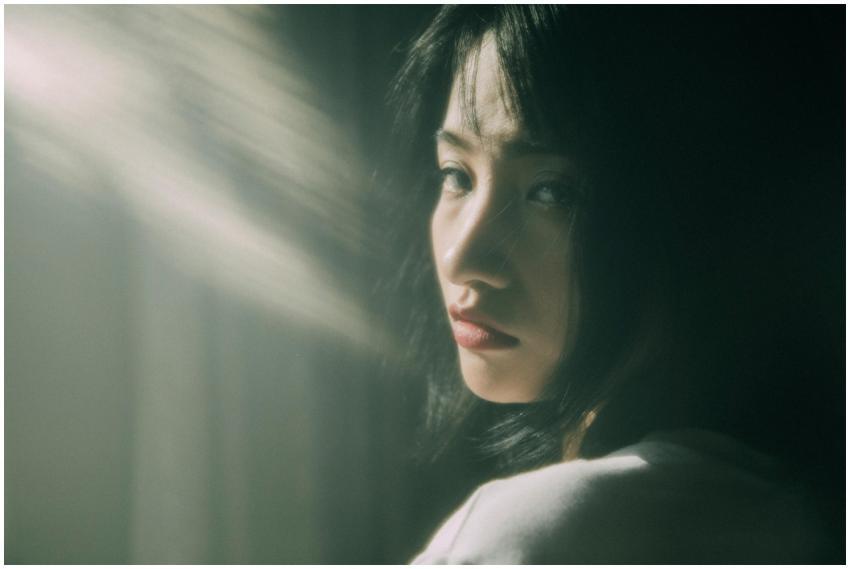 Portrait of a thoughtful young woman in soft sunli