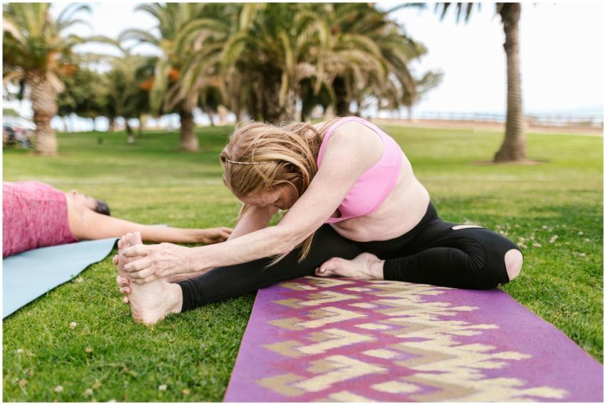 Senior woman in pink sportswear practicing yoga ou