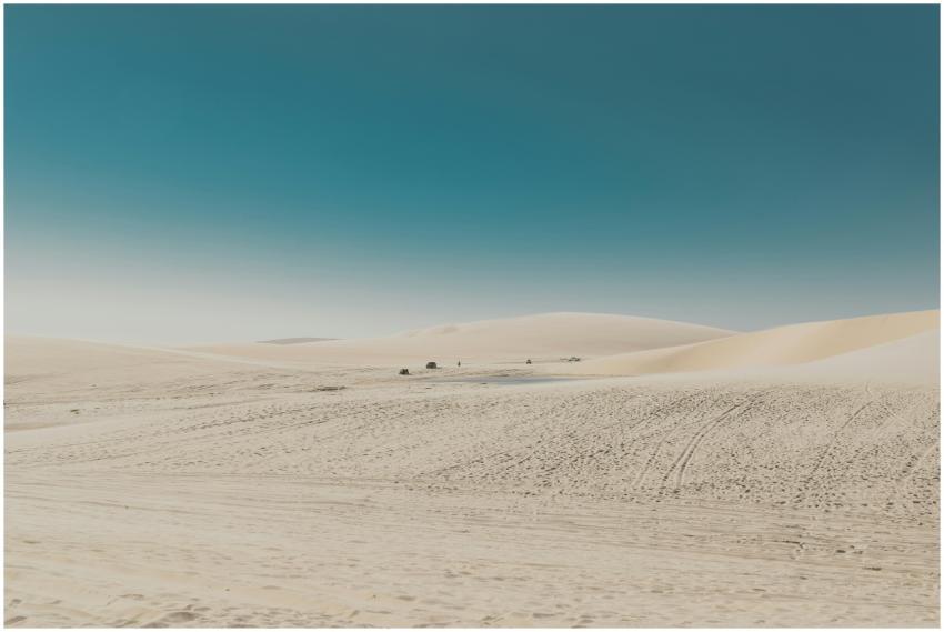 Vast desert landscape with rolling dunes and a bri