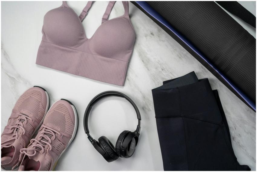 Flat lay of pink sportswear and accessories for a