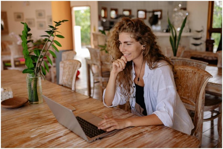 A woman enjoying remote work on her laptop in a co