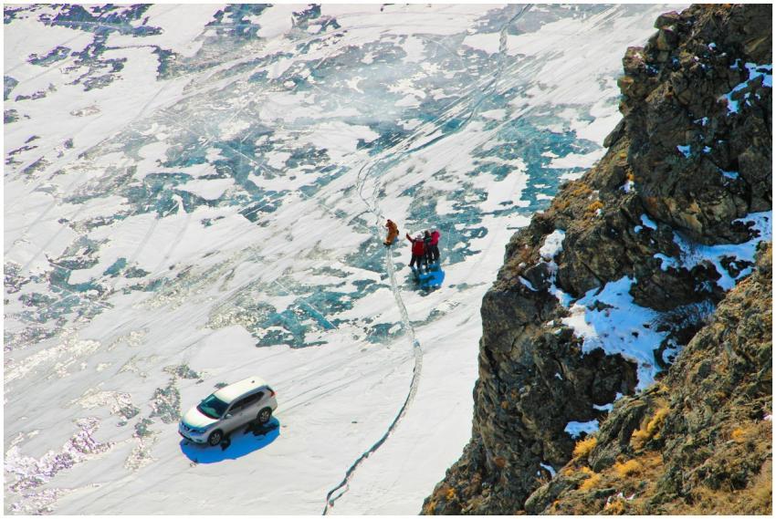 Hikers explore a snowy mountain trail near a parke